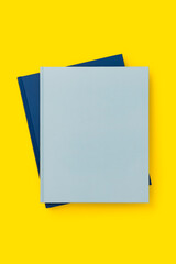 Blue books on yellow background, mockup