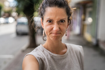 Portrait of adult caucasian woman stand in town or city outdoor in day