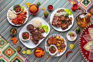 Traditional mexican food. Assortment of meat dishes from lamb: ribs, stew, clipping, barbecue. Colorful Food Table Celebration Delicious Party Meal Concept. 
