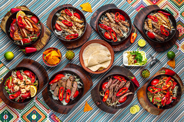 Traditional mexican food. Assortment of different fajitos from chicken, pork, beef, lamb and other types of meat. Colorful Food Table Celebration Delicious Party Meal Concept. 
