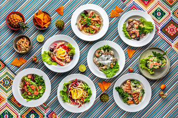 Traditional mexican food. A large selection of different salads with seafood, meat, and vegetables. Colorful Food Table Celebration Delicious Party Meal Concept. 