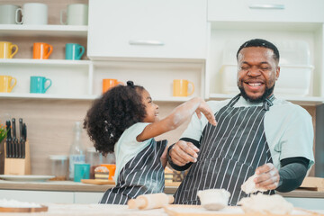 Kind African american parents teaching their adorable daughter how to cook healthy food, free space of kitchen, Happy black people family preparing healthy food in kitchen together