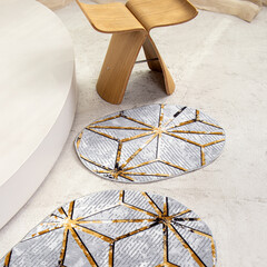 Two gray bath mats. Square. Large bath mat and a small one for the toilet. Rugs with ornaments...