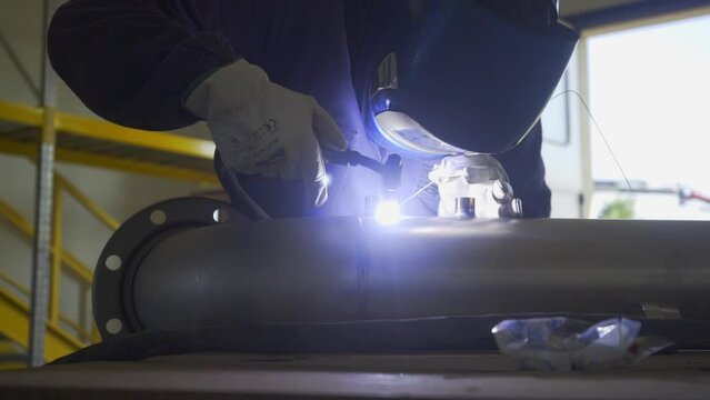 Man welding steel pipe