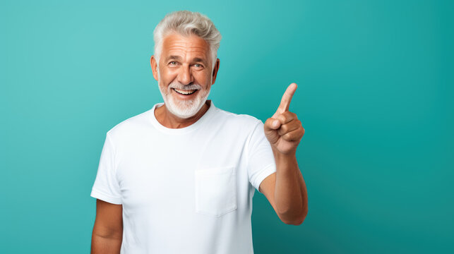 Senior Man Wearing White T-shirt Pointing With Hand And Finger To The Side Looking At The Camera.