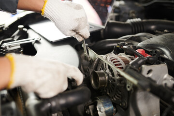 Closeup image of mechanic using wrench when repairing car for client
