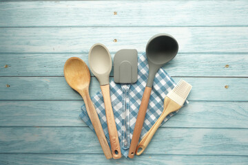 wooden cutlery forks and spoon on table cloth on blue table 