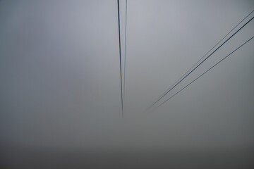 Low angle view of cable car in a foggy morning