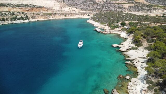 Drone shot of a white yact sailing off the coast of Turkey.