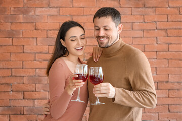 Happy young couple drinking wine in kitchen
