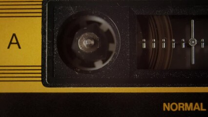 Cassette tape player rolling, macro shot. A vintage music seamless loop template video, with a natural color aesthetic