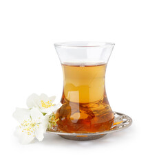 Cup of tea and jasmine flowers on white background