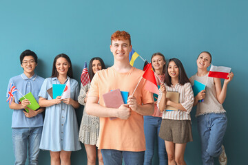 Young students of language school with flags on blue background © Pixel-Shot
