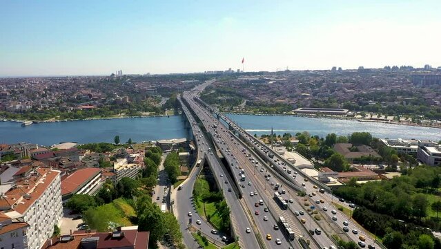 4K aerial panoramic shooting of Golden Horn of Istanbul. Drone zooming in towards Atat&uuml;rk Bridge over Golden Horn in sunny daylight against the historical walled city and Ey&uuml;p stock video.