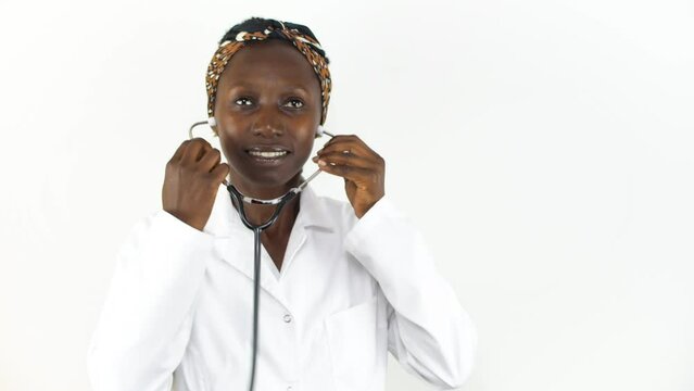 Young female doctor pusing her stethoscope isolated on white background 
