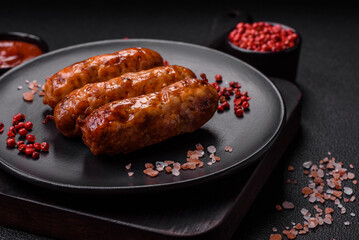 Delicious juicy grilled sausages with salt, spices and herbs