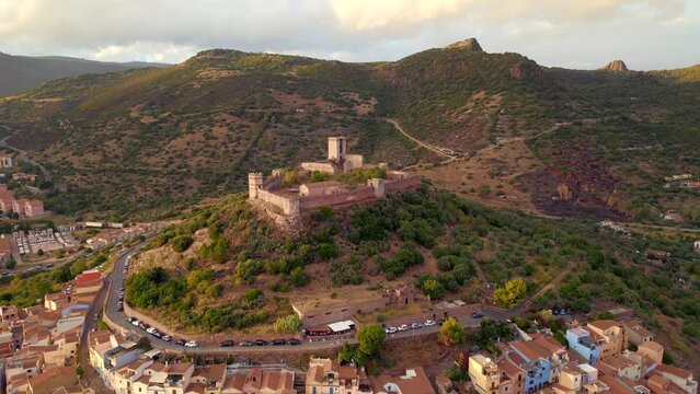 Bosa, Sardinia, Italy - August 21, 2023: Video from above, aerial view of the beautiful village of Bosa with colorful houses and a medieval castle. Bosa is located in the northwest of Sardinia, Italy.