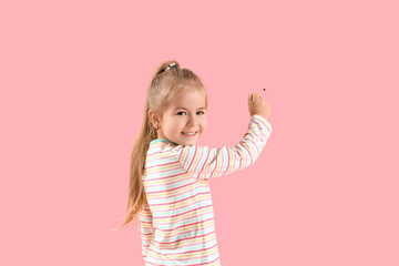 Cute little girl with paint brush on pink background