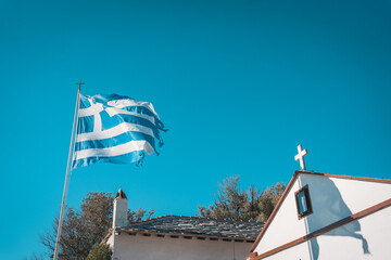 Greek flag flying over chapel in Greece