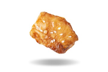 Spice teriyaki chicken with sesame seeds on a white isolated background