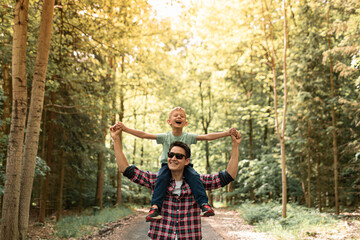Playful father and son enjoying time together in nature setting 