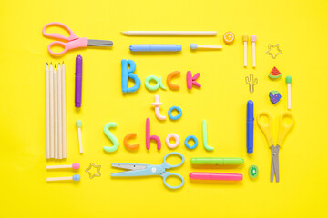 Text BACK TO SCHOOL and stationery on yellow background
