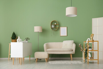 Interior of stylish living room with white sofa, pouf and sideboard