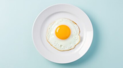  Fried egg with yellow yolk served on blue ceramic plate