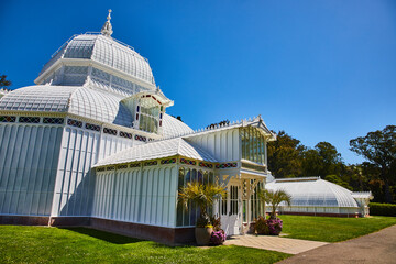 Exterior of Conservatory of Flowers building with bright sunny day and clear blue skies