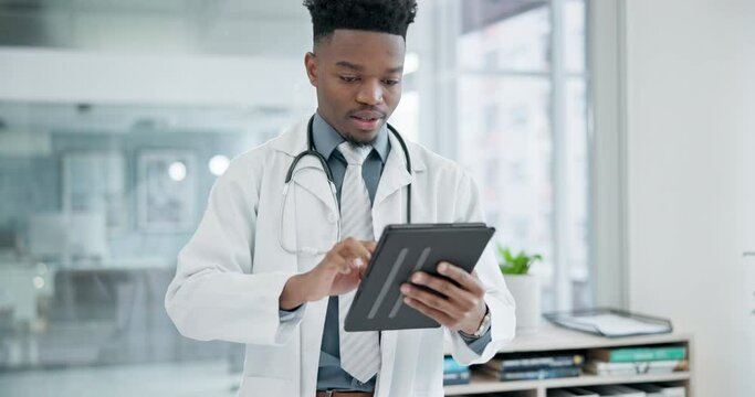 Research, tablet and a doctor black man in the hospital for healthcare or innovation in modern treatment. Medical, technology and data with a happy medicine professional in a clinic for breakthrough