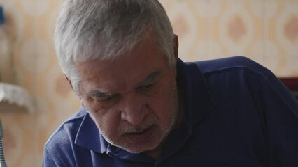 Elderly Man Experiencing Heart Attack, Falling by Home Kitchen Sink. Sickly senior male caucasian person suffering from cardiovascular PAIN and needing medical emergency