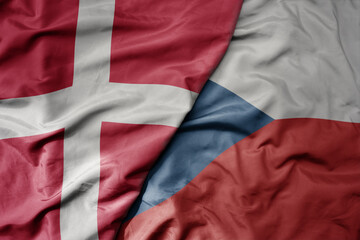 big waving national colorful flag of denmark and national flag of czech republic .