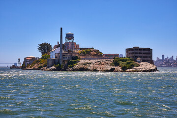 Close view of east side of Alcatraz Island on bright summer day with clear blue skies