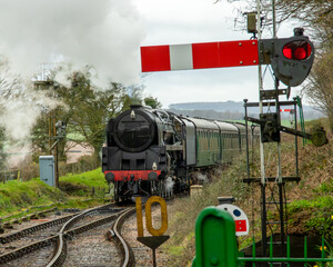 old steam locomotive approaching a station in England