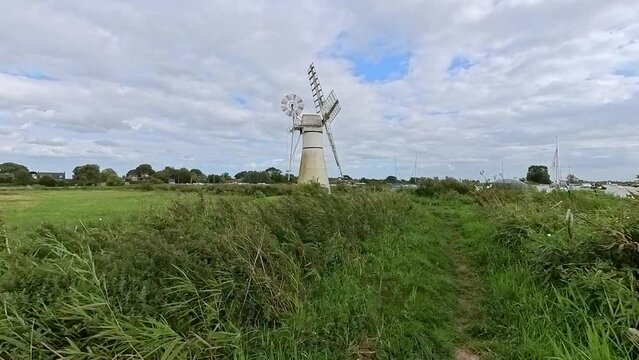 A traditional drainage mill on the bank of the River Thurne in the Norfolk Broads National Park