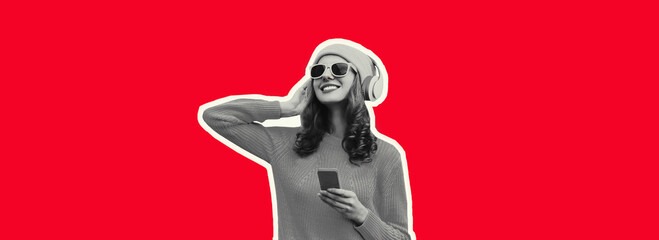 Portrait of stylish modern happy young woman listening to music in headphones with phone wearing hat, sunglasses on red background
