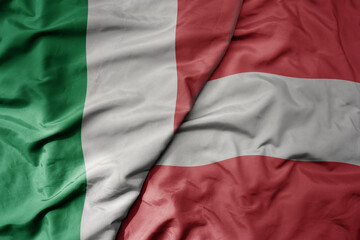 big waving national colorful flag of italy and national flag of austria .