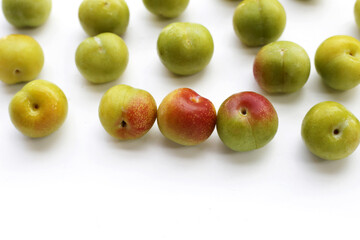 Fresh green plum on white background