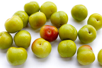 Fresh green plum on white background