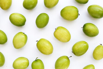 Green jujube fruits on white background.