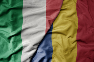 big waving national colorful flag of italy and national flag of romania .