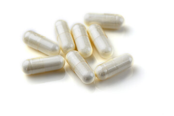 vitamins in capsules on a white background