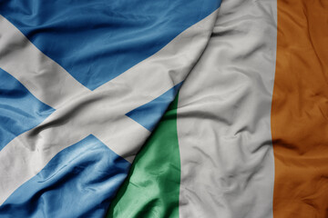 big waving national colorful flag of scotland and national flag of ireland .