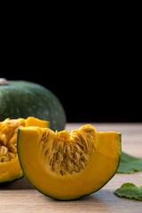 Green pumpkin on wooden with black background, Organic vegetable in autumn season