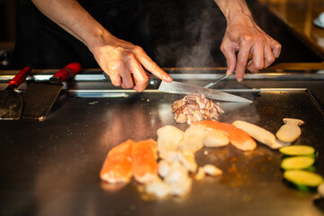 Chef cooking in Japanese teppanyaki restaurant
