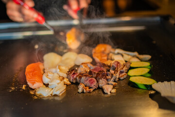 Chef cooking in Japanese teppanyaki restaurant