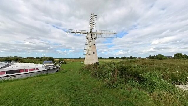 A traditional drainage mill on the bank of the River Thurne in the Norfolk Broads National Park