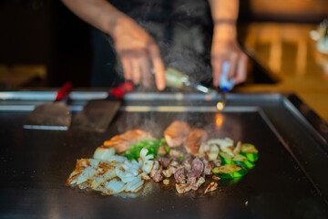 Chef cooking in Japanese teppanyaki restaurant