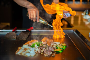 Chef cooking in Japanese teppanyaki restaurant