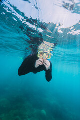 woman using a stinger suit in the great barrier reef in summer time .